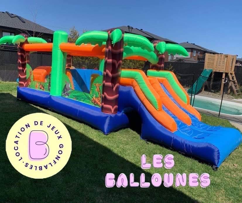 Enfants jouant dans le jeu gonflable Jungle Tropicale installé à l’extérieur sur la neige sur la Rive-Nord de Montréal, location hivernale Les Ballounes